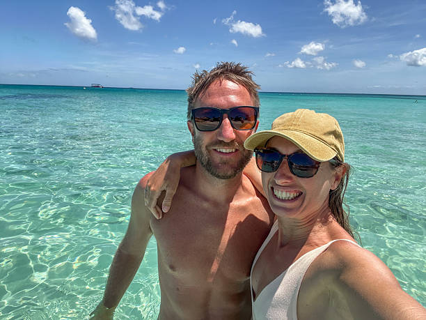 istock Happy couple enjoying a sunny day at the beach 2210731946