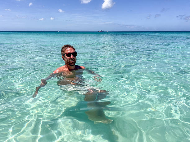 istock Man Relaxing in Crystal Clear Ocean Water 2210731961