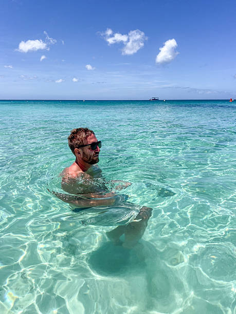 istock Man Relaxing in Crystal Clear Ocean Water 2210731968
