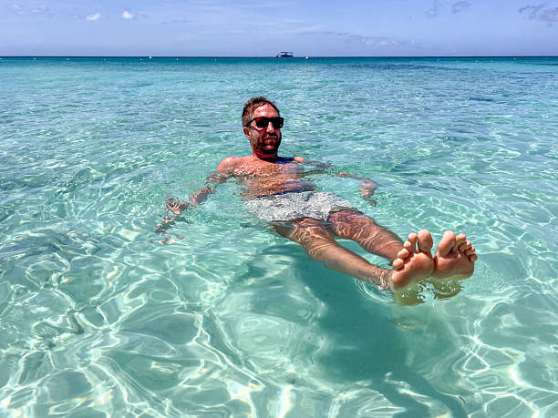 istock Man Relaxing in Crystal Clear Ocean Water 2210731980