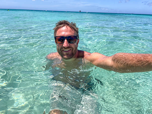 istock Man Enjoying a Swim in Clear Tropical Waters 2210732001
