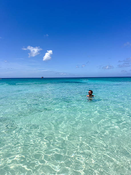 istock Man Relaxing in Crystal Clear Ocean Water 2210732012