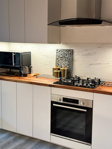istock Image of modern kitchen, chimney extractor fan, worktops, countertops, cupboard lighting, kitchen lights, central island / contemporary interior design 2210733613