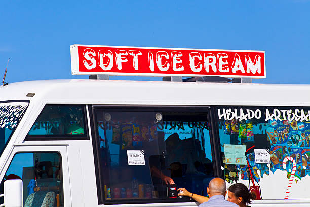 Close-up view of stationary ice cream van by Baldaio beach, A Coruña province, Galicia, Spain. Couple buying.