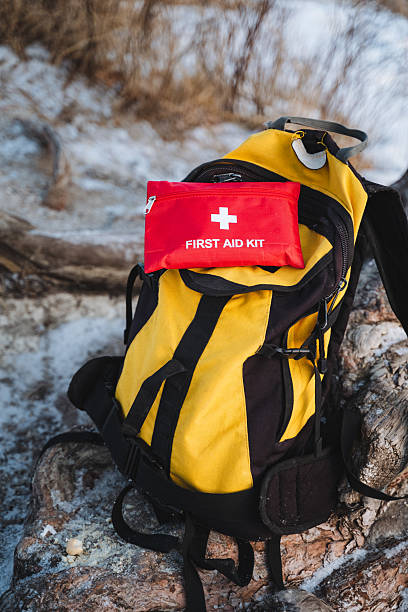 istock A bright and vibrant yellow backpack that is equipped with a red first aid kit on top is absolutely essential for all kinds of outdoor adventures, ensuring safety in case of emergencies 2210737165