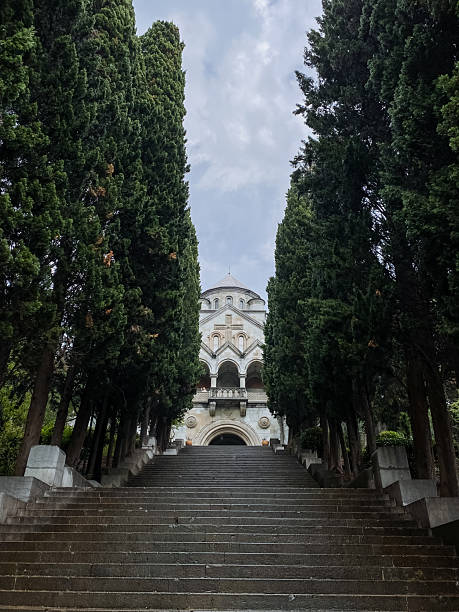 istock A beautiful staircase ascends towards a magnificent building that is elegantly surrounded by lush green trees, creating a picturesque scene of nature and architecture in harmony 2210737264