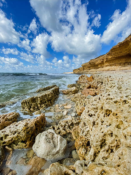 istock A beautiful rocky beach under a vibrant blue sky with fluffy clouds creates a serene atmosphere that invites relaxation and contemplation for all who enjoy its natural beauty 2210737402