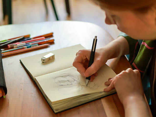 istock A young woman draws in a sketchbook 2210740086