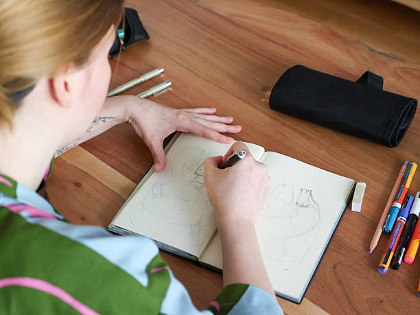 istock A young woman draws in a sketchbook 2210740115