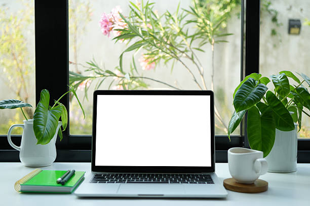 istock Laptop with white screen and coffee drink, cozy indoor work space 2210740292