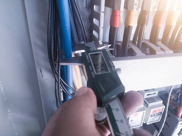 istock Measuring the diameter of a power cable using a digital vernier caliper 2210740993