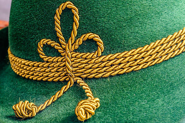 istock Decorative green felt hat featuring intricate golden rope detailing, showcasing craftsmanship and tradition in headwear design 2210741098