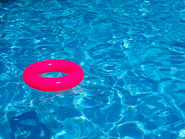 istock Neon Pink Inflatable Ring In a Swimming Pool 2210741132