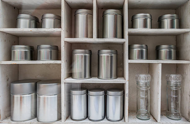 istock Display of silver storage containers arranged neatly in a wooden shelf in a rustic setting 2210741158