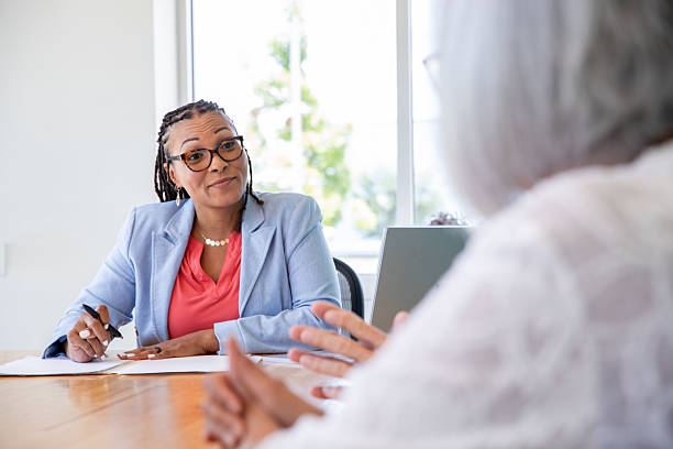 istock Professional estate planner meets with senior clients in modern office 2210741571