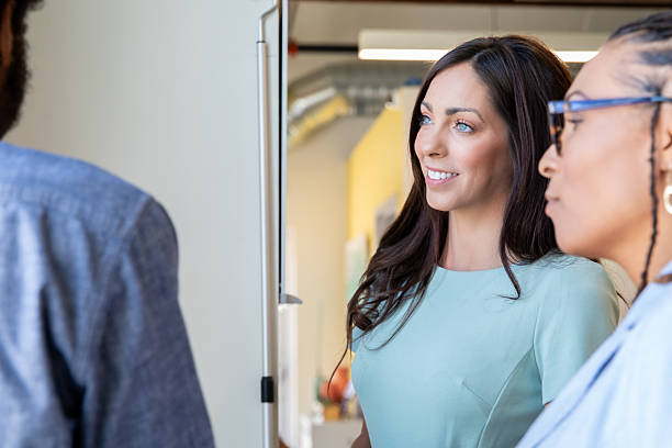 istock Diverse coworkers meet around water cooler in modern office 2210741623