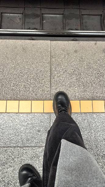 istock A person standing at the edge of a subway platform 2210745156