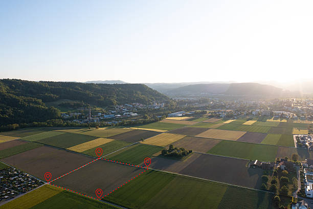 istock Land plot management - real estate concept with a vacant land parcel available for building construction - housing concept with a red house icon 2210749499