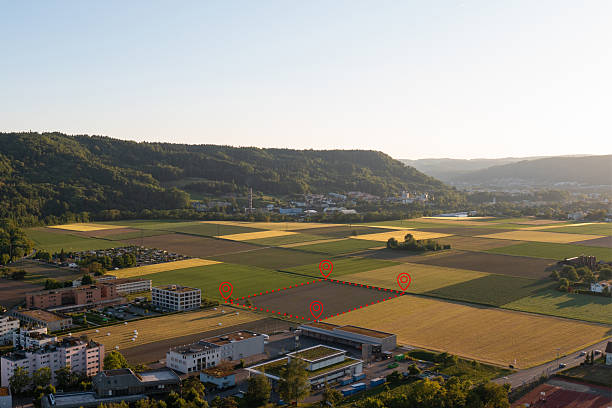 istock Land plot management - real estate concept with a vacant land parcel available for building construction - housing concept with a red house icon 2210749506