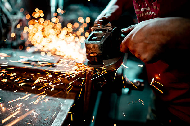istock Grinding Metal with Sparks Flying in an Industrial Workshop 2210751617