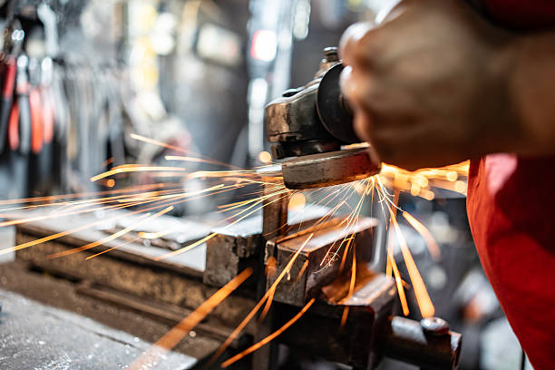 istock Industrial Worker Grinding Metal with Bright Sparks in Heavy Machinery Workshop 2210751735