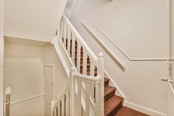 istock Lovely staircase design with red carpet 2210755557