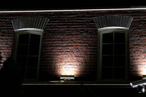 istock Elegant brick building illuminated at night with soft background lighting 2210756600