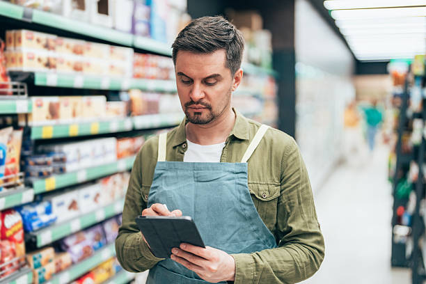 istock Supermarket Employee Taking Inventory with Digital Tablet 2210760509