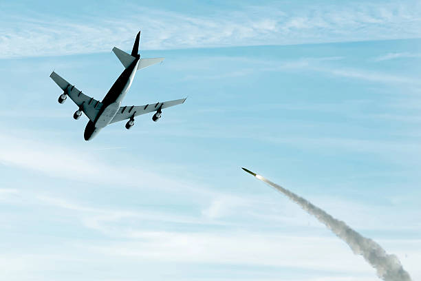 istock A combat missile, smoke and fire from a rocket are flying into a passenger or cargo plane. Concept: downed plane, missile attack, air alert, 2210771465