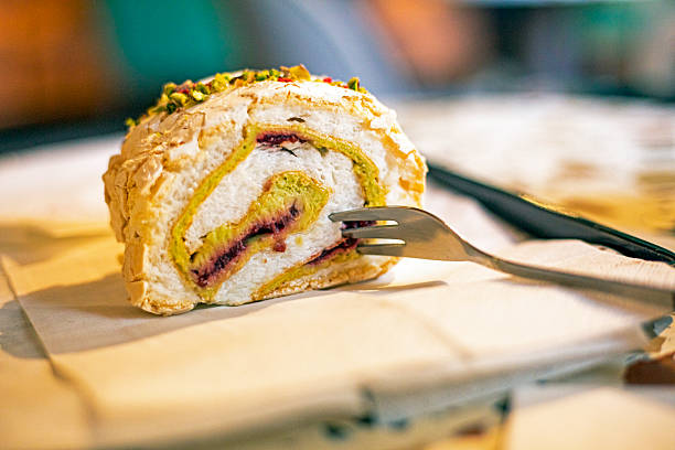 meringue roll with pistachio and raspberry. Popular desserts
