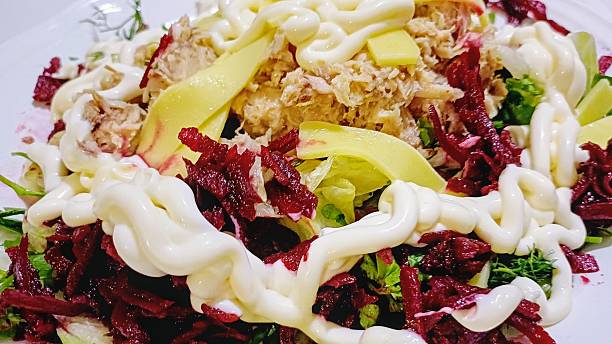 istock Green tuna salad on a white plate 2210773038