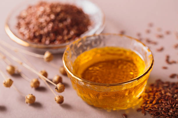 istock Brown linen seeds, flaxseed vegetable oil on beige background 2210774912
