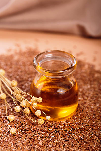 istock Brown linen seeds, flaxseed vegetable oil on beige background 2210774939