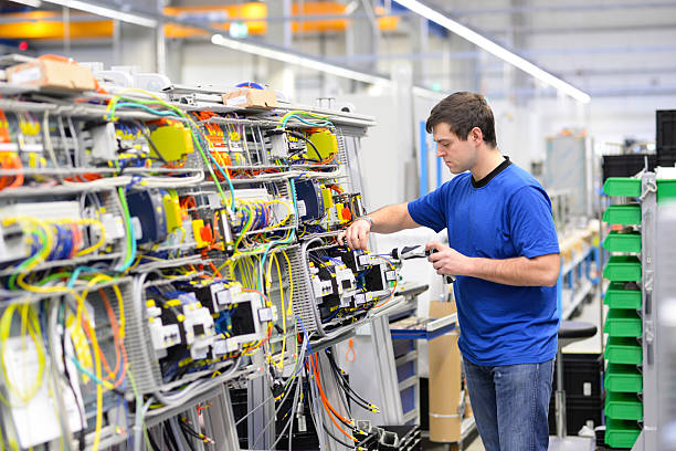 istock young operator assembles machine in a modern high tech factory - production of switch cabinets for industrial plant 2210775264