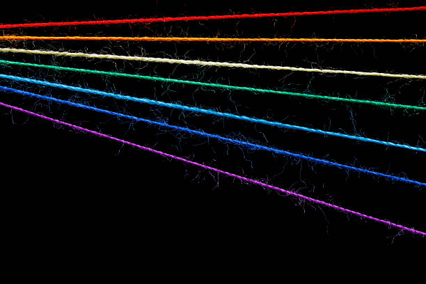 istock multicolored sewing threads in the form of a rainbow on a black background 2210776430