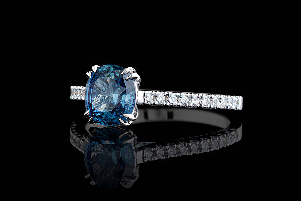 istock white metal ring, silver, gold with sapphire stone, diamonds on black background 2210776596