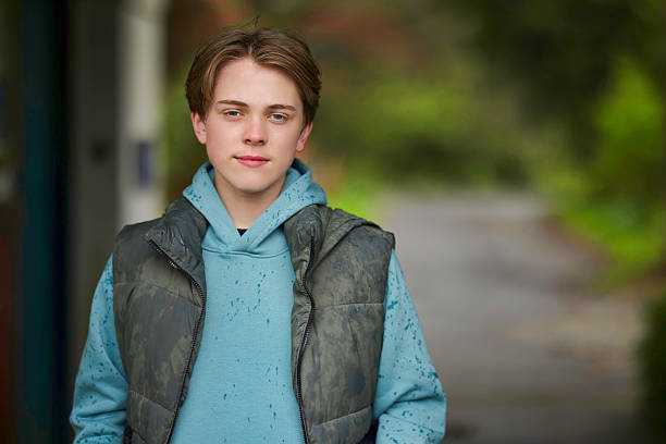 istock Teen boy outdoors on a rainy day 2210776761