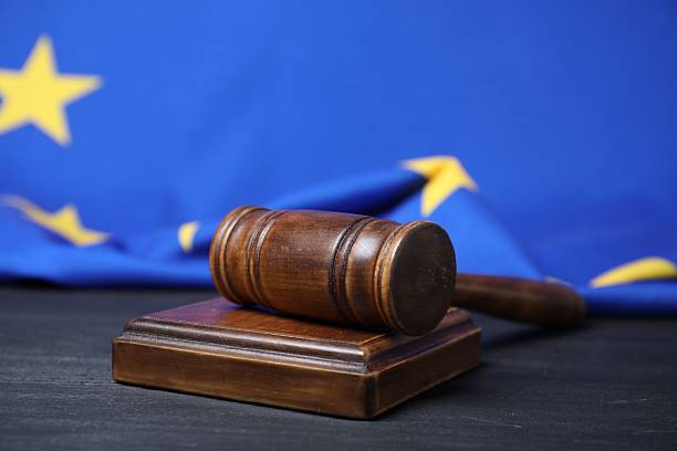 istock Judge's gavel on grey table against European Union flag 2210778609