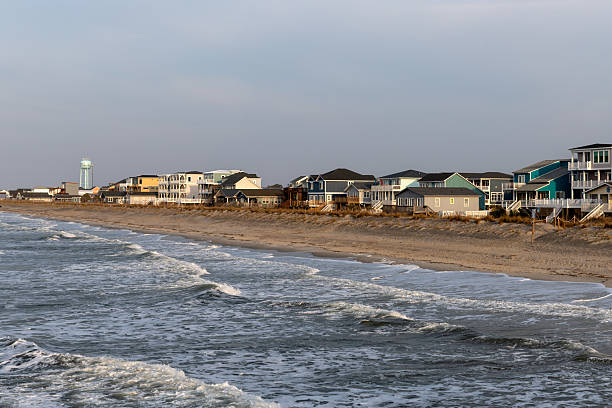 istock Waves Crash Near Oak Island Beach Homes 2210780721