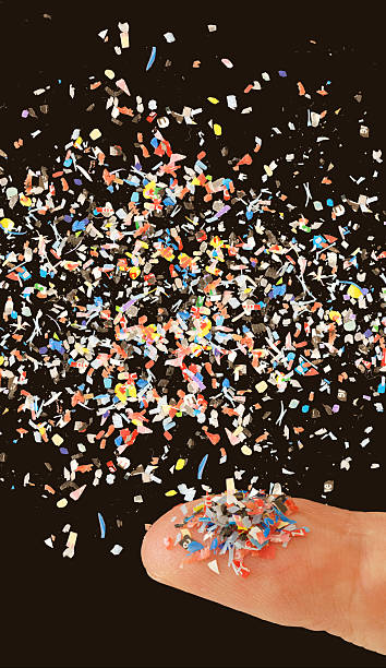 istock Close up of microplastic on finger concept of water plastic pollution and global warming 2210785183
