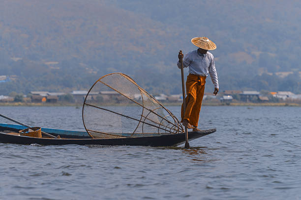 istock Fisherman rowing with leg on inle lake, myanmar 2210786156