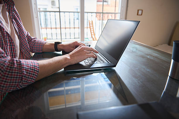 istock Freelancer Working Remotely on Laptop in Bright Modern Home Environment 2210788840