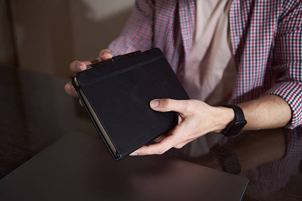 istock Young Professional Holding a Notebook in a Home Office Setting 2210788857