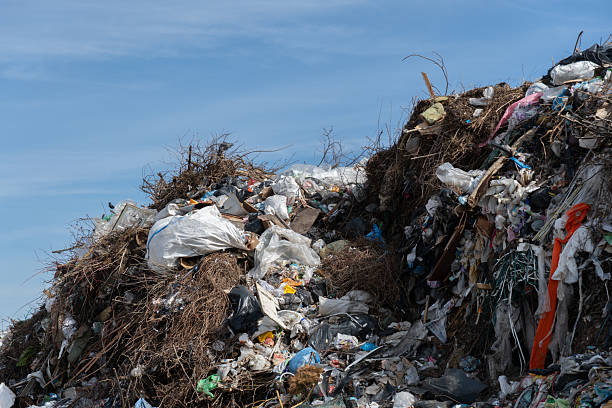 istock Large heaps of garbage and debris are stacked at a disposal site, highlighting issues related to waste management and environmental pollution in the area 2210789043