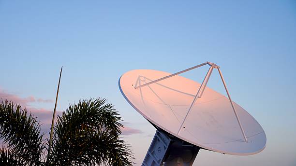 istock Large parabolic satellite dish antenna pointing at the sky at sunset 2210789552