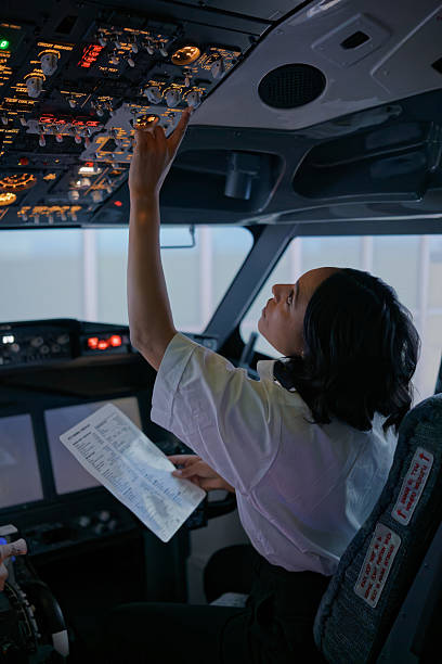 istock Co-Pilot Checking the Upper Panel of Passenger Jet After Startup 2210790014