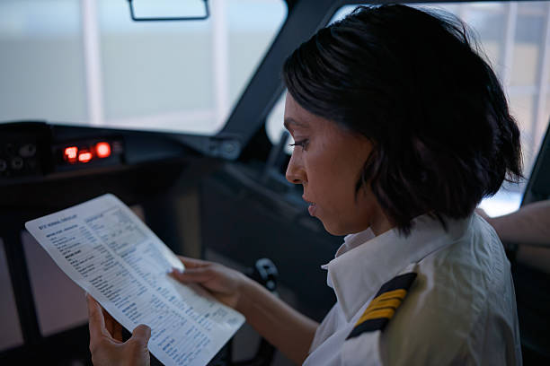 istock Co-Pilot Looks Goes Over Normal Checklist Inside of a Passenger Jet Cockpit 2210790017