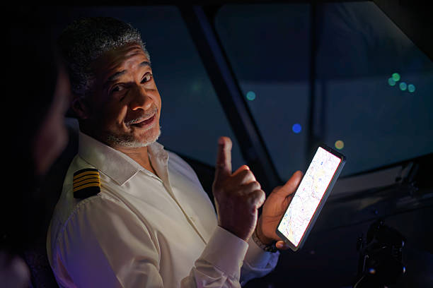 istock Charismatic Pilot with Raised Finger Looks at His Co-Pilot 2210790036