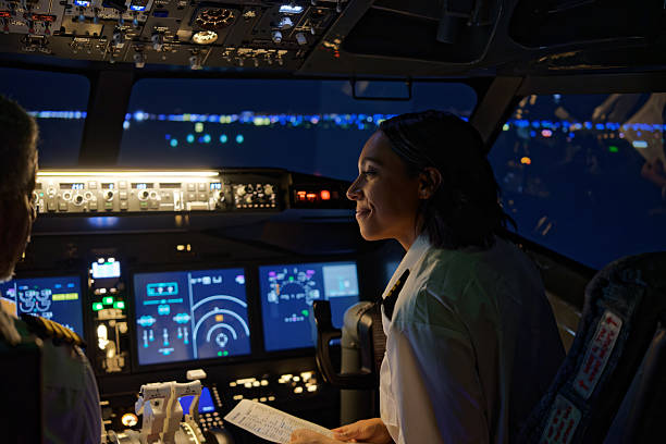Co-pilot Smiles as She Looks to The Pilot Sat Next to Her - Night