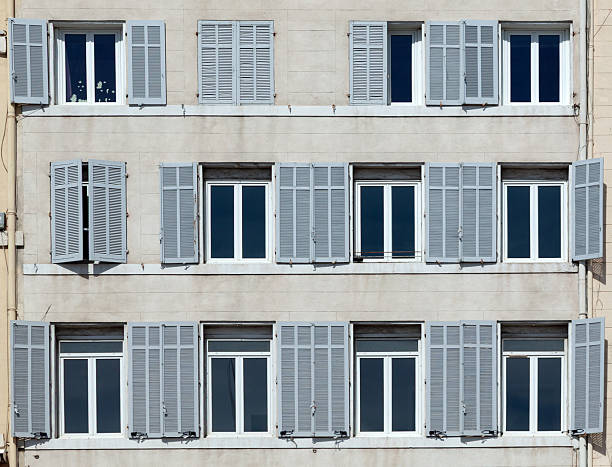 istock typical facade of an old hotel with open and closed shutters 2210791644